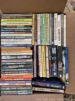 Top view of two boxes filled with various paperback books, mostly Agatha Christie titles and other mystery and fiction paperbacks.