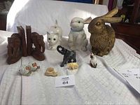 Wide view of all animal decor items including rabbits, cat, elephant bookends, netsuke, and salt and pepper shakers.