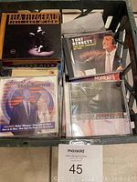 Photo of CDs featuring Ella Fitzgerald, Tony Bennett, Mel Torme, and Navy Charles in a plastic crate.