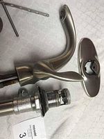 Koehler single lever faucet with escutcheon plate and threaded mounting shank showing bottom assembly parts.