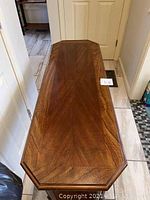 Top view of the wooden sofa table showing the burled wood grain pattern on the tabletop.