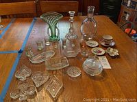 Overview of all glassware and china pieces on wooden table, showing full assortment.