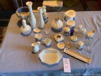 Overview photo showing a diverse grouping of white milk glass, hobnail texture items, and clear glass items arranged on a cloth.