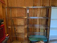 Front view of two metal wire shelving units side by side in a garage space, showing full height and width, empty shelves.