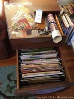 Overall view of wooden drawers holding file folders of craft patterns and loose papers; wooden drawer contains hanging files.