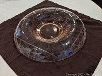 Full top and side view of the pink depression glass bowl showing the round shape, sunken center, and rolled edge.