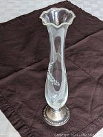 Image showing vase from front angle to highlight etched tendril design and sterling silver base