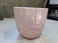 Front view of large pink McCoy planter showing vertical ridges and floral relief pattern.