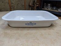 Side view of the white Corningware pan showing the Blue Cornflower floral design on the exterior side.