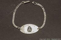 Full view of the sterling silver sweetheart ID bracelet with chain and clasp visible on dark background.