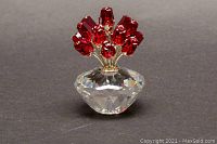 View of the Swarovski crystal red roses bouquet figurine showing eleven red crystal roses on a clear faceted base.