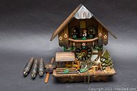 Front overview of clock with weights, pendulum and decorative elements