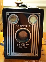 Front view of the Kodak Brownie Target Six-20 camera highlighting the lens, flash bulb sockets, and branding.