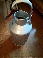 Full view of the vintage metal oil can showing the handle and embossed text on top reading 'PROPERTY STD. OIL CO. OF CALIF.'