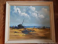 Frontal view of vintage oil painting titled 'Beached' by Galado. Shows beach landscape with boat and figures, wood frame visible.