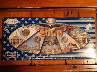 Front view of the commemorative quarter collection box with coins in original packaging showing ten quarters, patriotic American-themed design, and text indicating 2000 Millennium collection.
