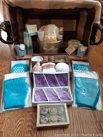 Full basket contents arranged on the floor showing all bath retreat items included in the lot.
