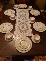 Top-down view of eight place settings arrayed on table