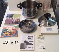 Fagor stainless steel pressure cooker with lid, steaming basket, pressure regulator, measuring cup, and Fagor brand pressure cooker cookbooks and instruction manuals.