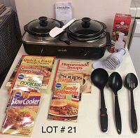 Photo of Crock Pot 2-sided electric cooker, spatula, manual chopper, four black utensils, and four colorful cookbooks on a table.
