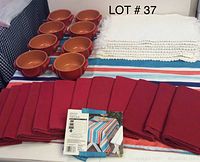 8 terracotta bowls, 12 red napkins, 12 white napkins, multicolored striped table cloth