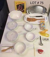 Overview of Corning Ware blue cornflower dishes, kitchen utensils, and cookbook