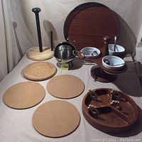 Photo showing the full wood set with tray, divided bowl, paper towel holder, cork trivets, wooden holder with ceramic bowls and ladles, and metal bowl with lid, against a neutral backdrop.