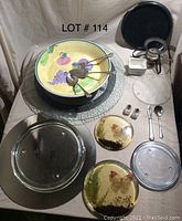 Full view of entire lot showing bowl, utensils, trivets, glass mirror, and bowl warmer pieces
