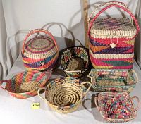 Photo of 7 assorted woven baskets in various shapes and colors arranged together with a ruler for size reference.