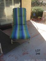 Front view of chaise lounge with striped removable cushion in place, showing the cushioned backrest and seat.