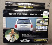 Photo of the unopened box showing branding, product images, and description of the wireless vehicle rear observation system for backup safety.
