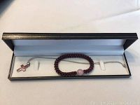 Full jewelry box containing necklace and bracelet laid out inside