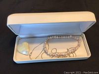 Full view of jewelry box containing freshwater pearl bracelet, sterling silver necklace, and mother of pearl heart pin.