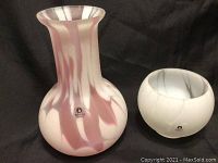 Photo showing vase and votive side by side on black fabric background, clearly displaying Pukeberg labels