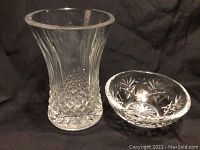 Two Waterford crystal pieces: vase on the left and bowl on the right, shown on black background