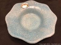 Top view of blue Murano glass dish with scalloped edge and silver plaque attached.