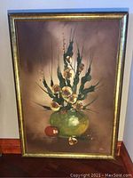 Full view of framed oil painting showing floral still life with green vase and signature.