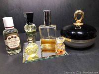 Wide shot showing all perfume bottles and Van Cleef & Arpels body cream container