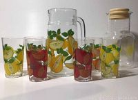 Full set of Arcoroc fruit motif pitcher and 6 juice glasses with colorful fruit designs including apples and pears.