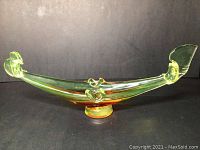 Front view of the shaded orange-yellow Murano-style glass gondola ashtray.