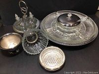 Overview of all items including Kromex Lazy Susan tray, cut glass sectionals, and condiment cruet set with silver plating.