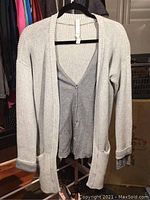 Gray Lululemon athletica cardigan hanging on black hanger