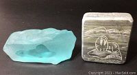 Front view of frosted glass paperweight and soapstone plaque showing detailed etchings of seals.