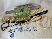 Full lot view showing jewelry pieces and loose beads with the vintage decorative box placed behind them and ruler for size scale.