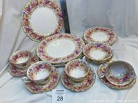 Full set arranged showing four each of dinner plates, side plates, fruit bowls, teacups, saucers
