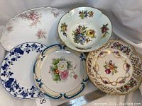 Five porcelain pieces: Limoges oval floral tray, Limoges pedestal bowl, Schumann floral bowl, Noritake blue floral platter, Royal Meissen blue and white floral platter shown together.