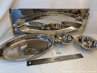 Photo of whole set showing large rectangular tray with brass handles, oval tray, and two small six-sided bowls with handles, ruler for scale.