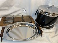 Full overview of all items showing the oval tray, Danish wood tray with smoked glass inserts, and black and chrome ice bucket