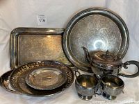 Full lot showing various silver plated platters, trays and coffee service items with tarnish