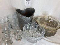 Full group image showing all lot items on white backdrop: pewter colored ice bucket, Pyrex lined silver serving dish, crystal bowl, and four glasses.